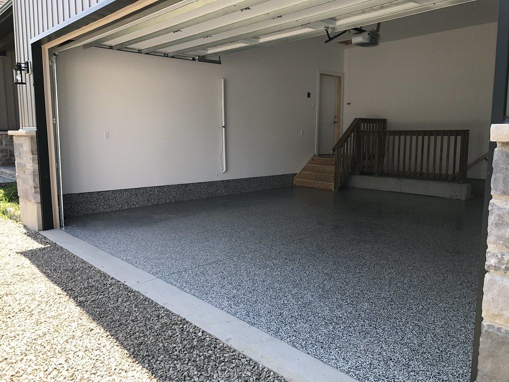 Finished grey flake epoxy garage floor in Cedar Rapids with glossy protective topcoat